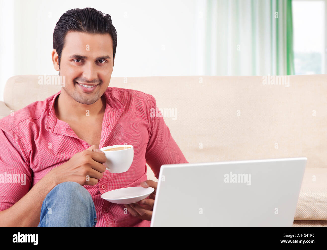 Young man drinking tea hi-res stock photography and images - Alamy