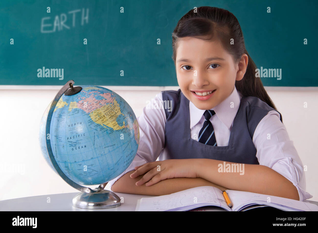 Indian school girl holding map hi-res stock photography and images - Alamy