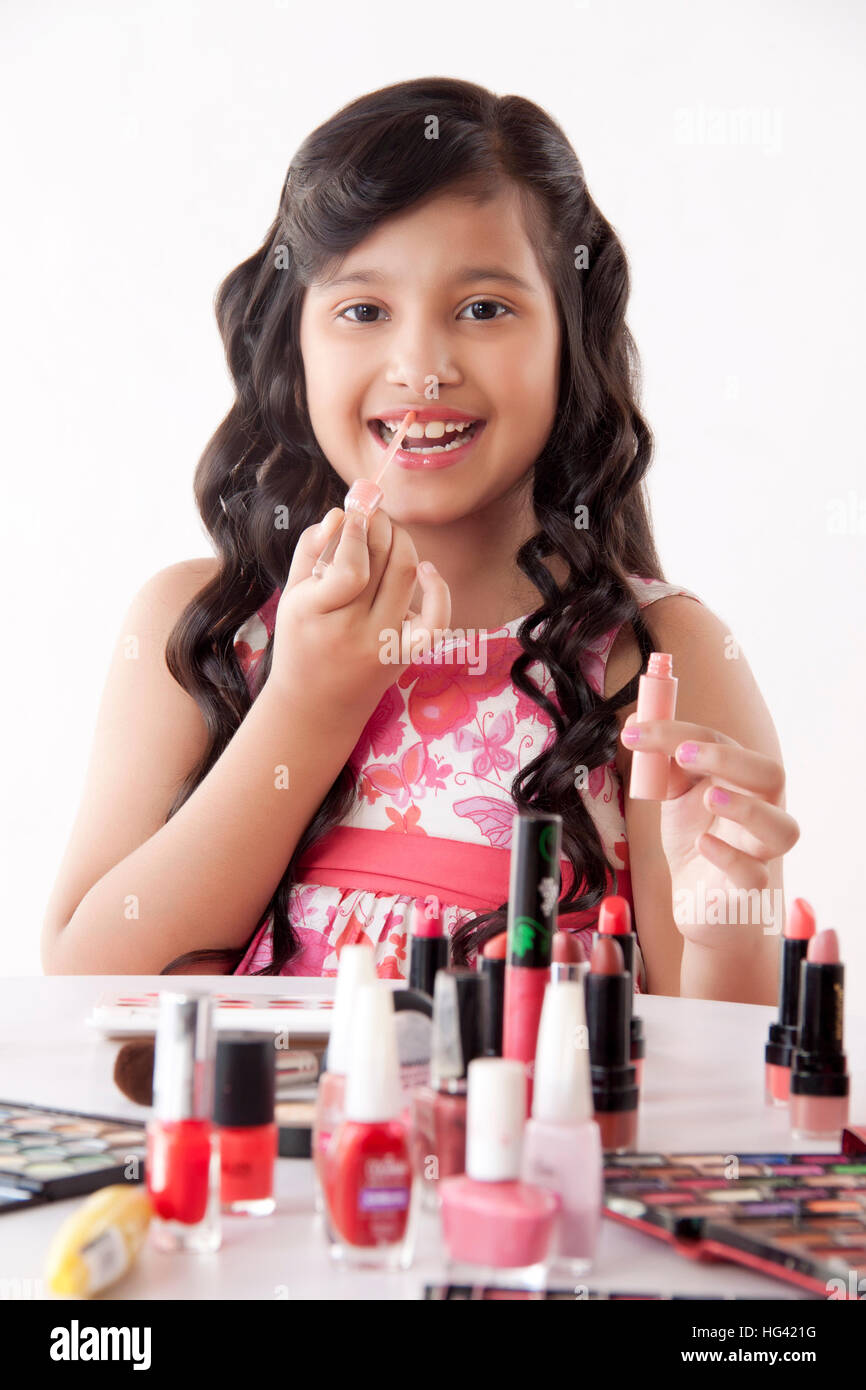 Cute girl applying lip gloss Stock Photo Alamy