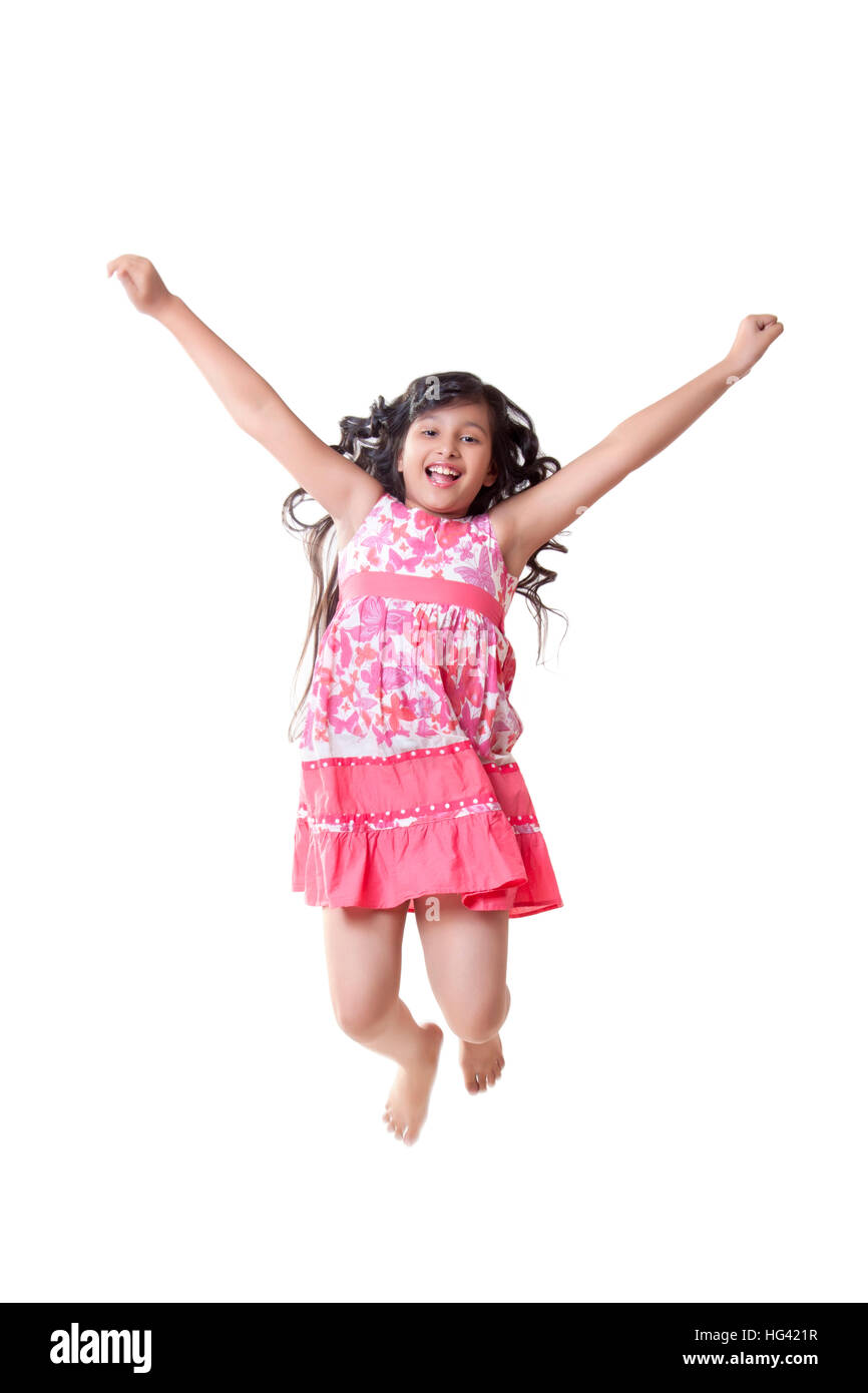 Portrait of cute girl jumping in air Stock Photo