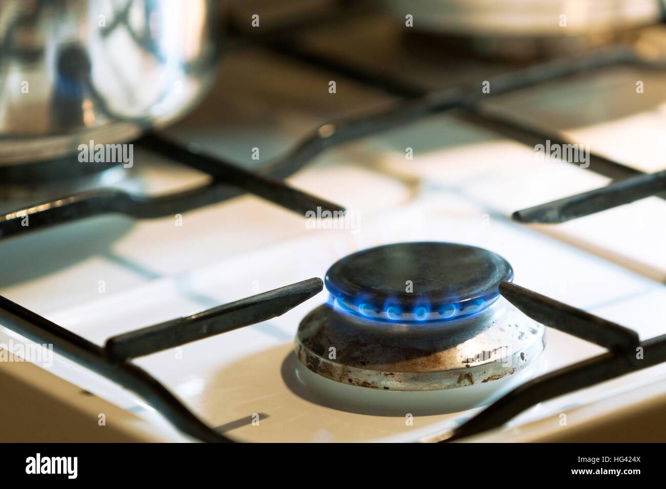 detail of a gas stove with lighted gas flame usage worldwide Stock