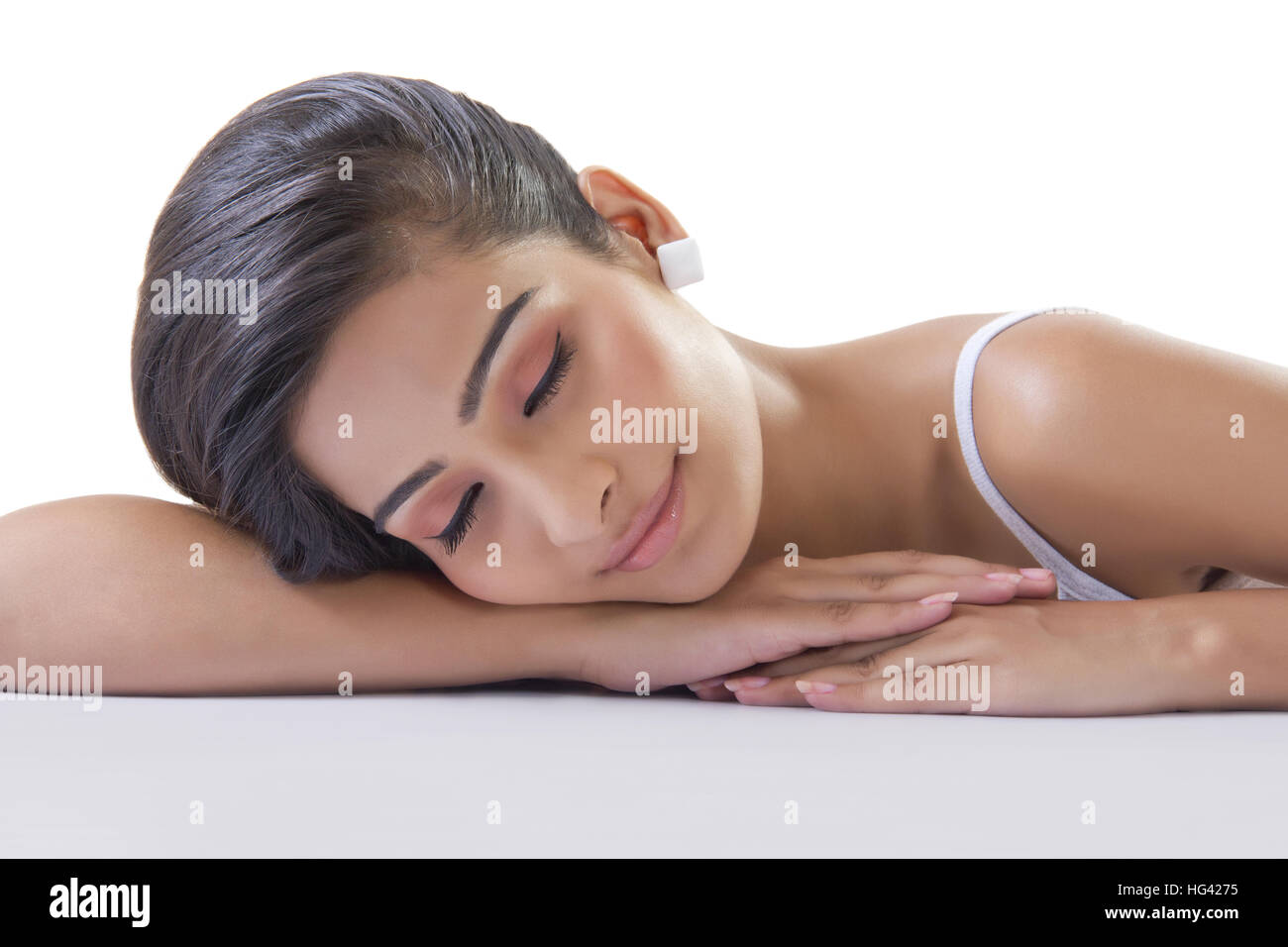 Beautiful young woman sleeping at desk Stock Photo