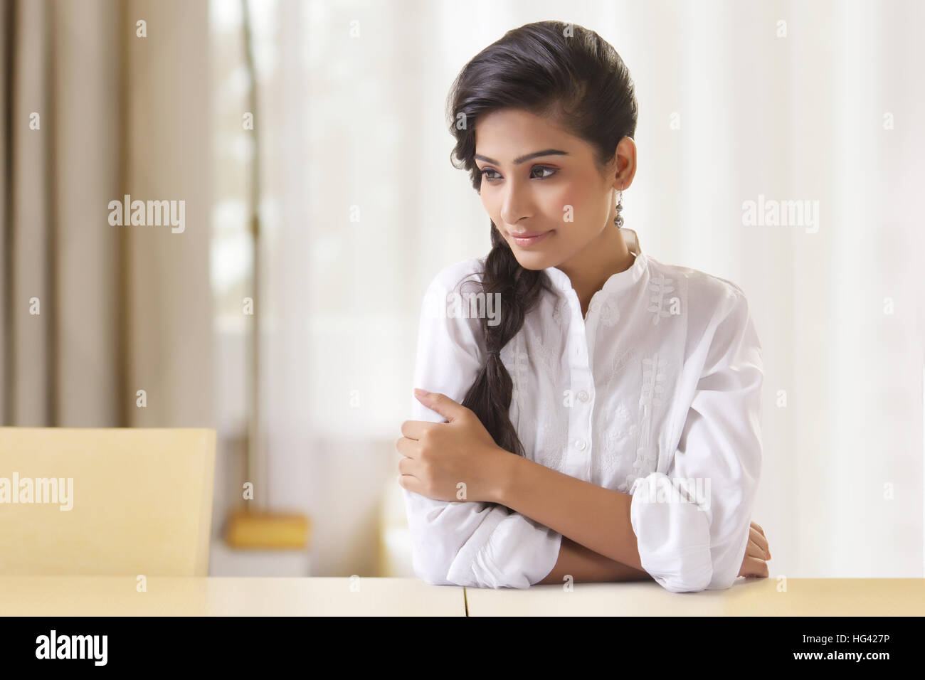Portrait of beautiful young woman with arms crossed Stock Photo - Alamy