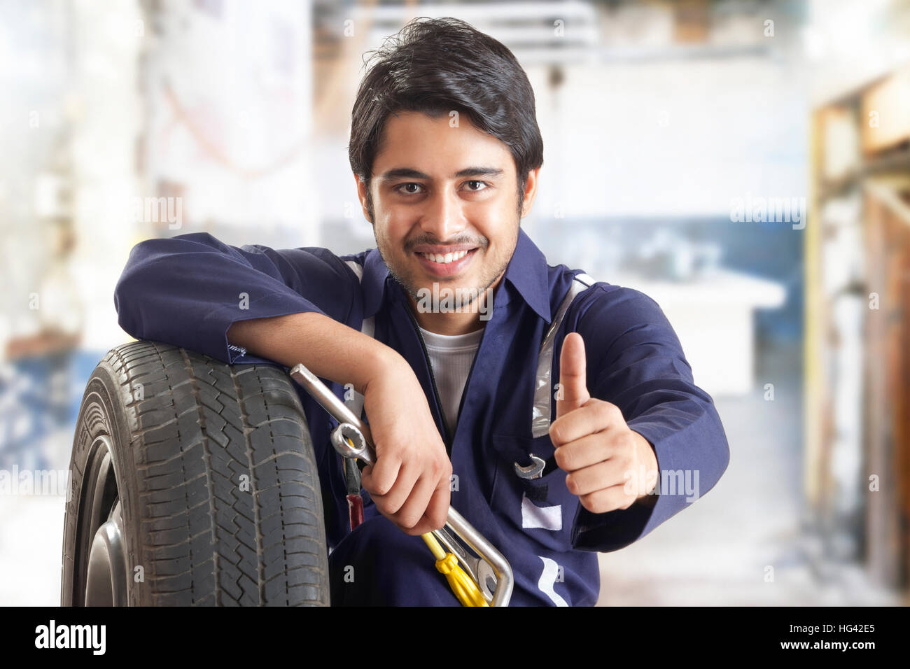 Portrait of car mechanic showing thumbs up Stock Photo
