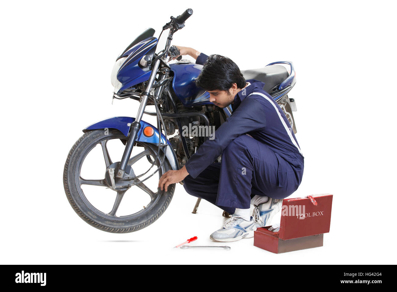 Mechanic working on motorcycle Stock Photo Alamy