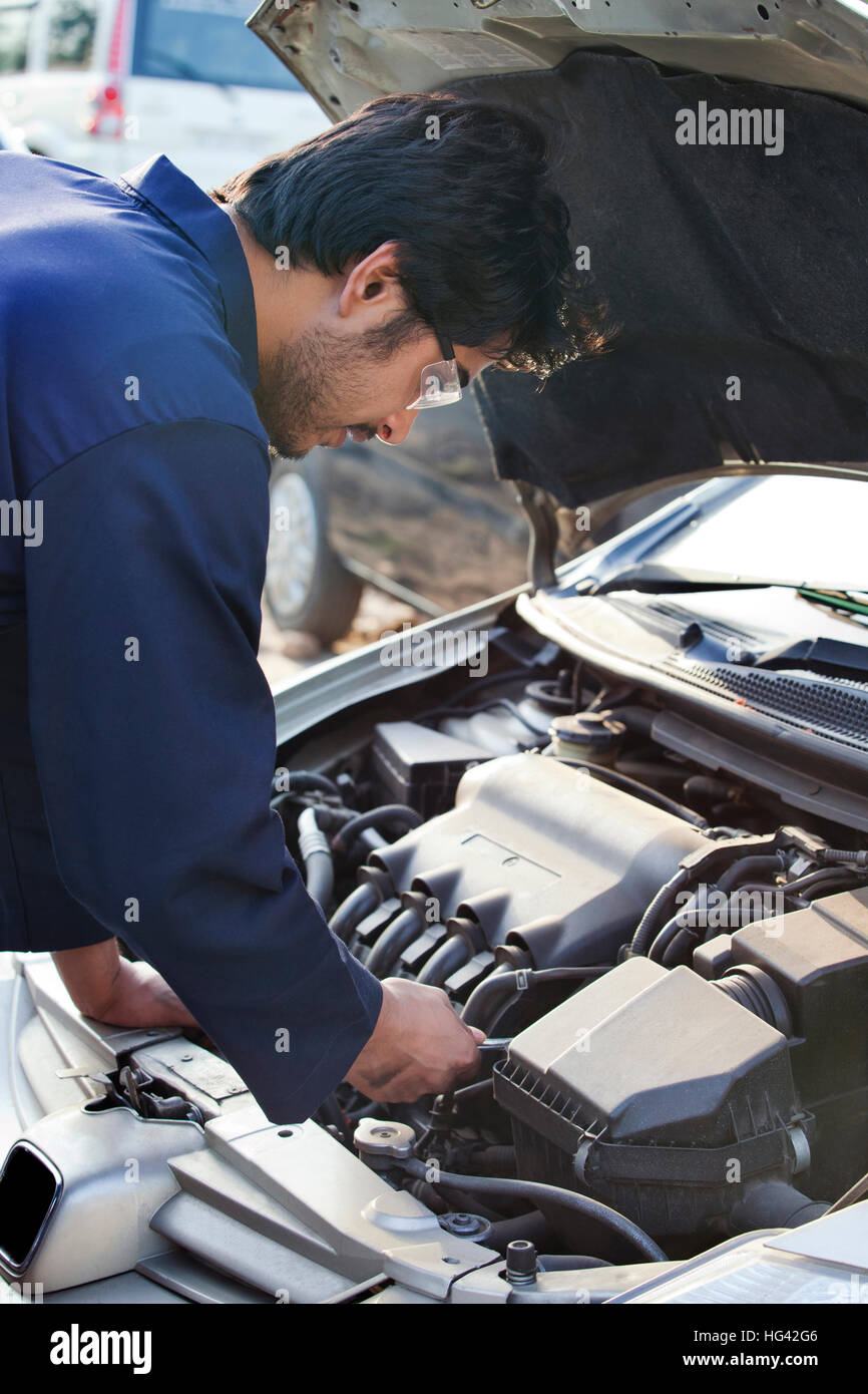 Mechanic repairing car engine Stock Photo - Alamy