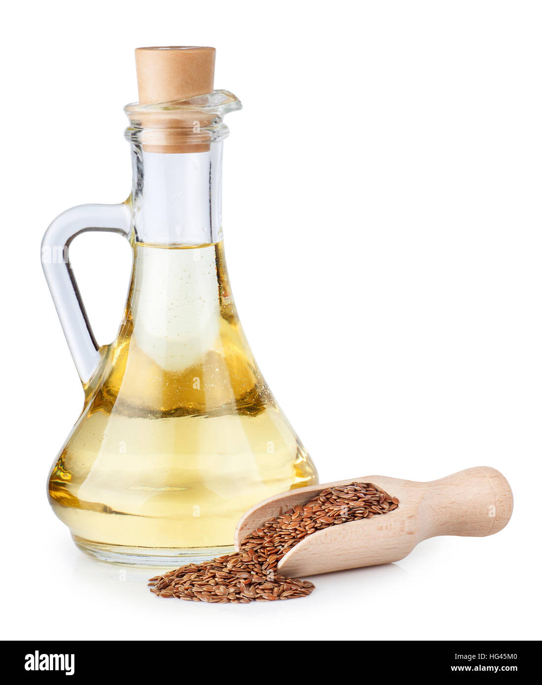 Linseed oil in glass bottle and flax seeds in wooden scoop isolated on white background Stock Photo