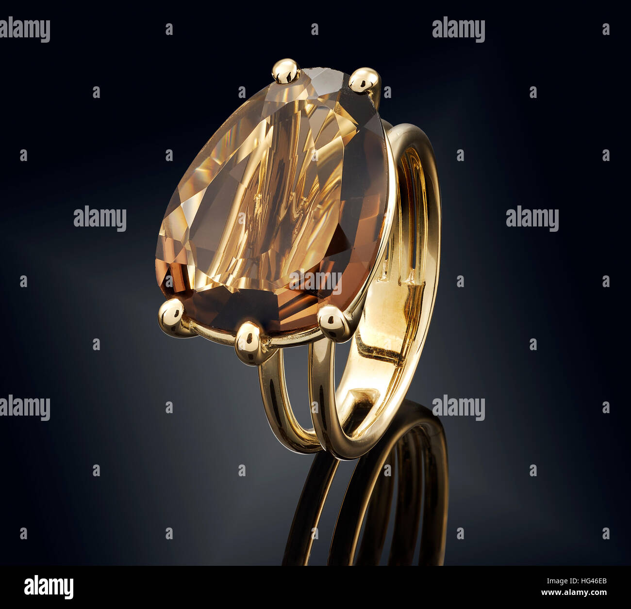 Golden ring with gemstone isolated on black background. Stock Photo