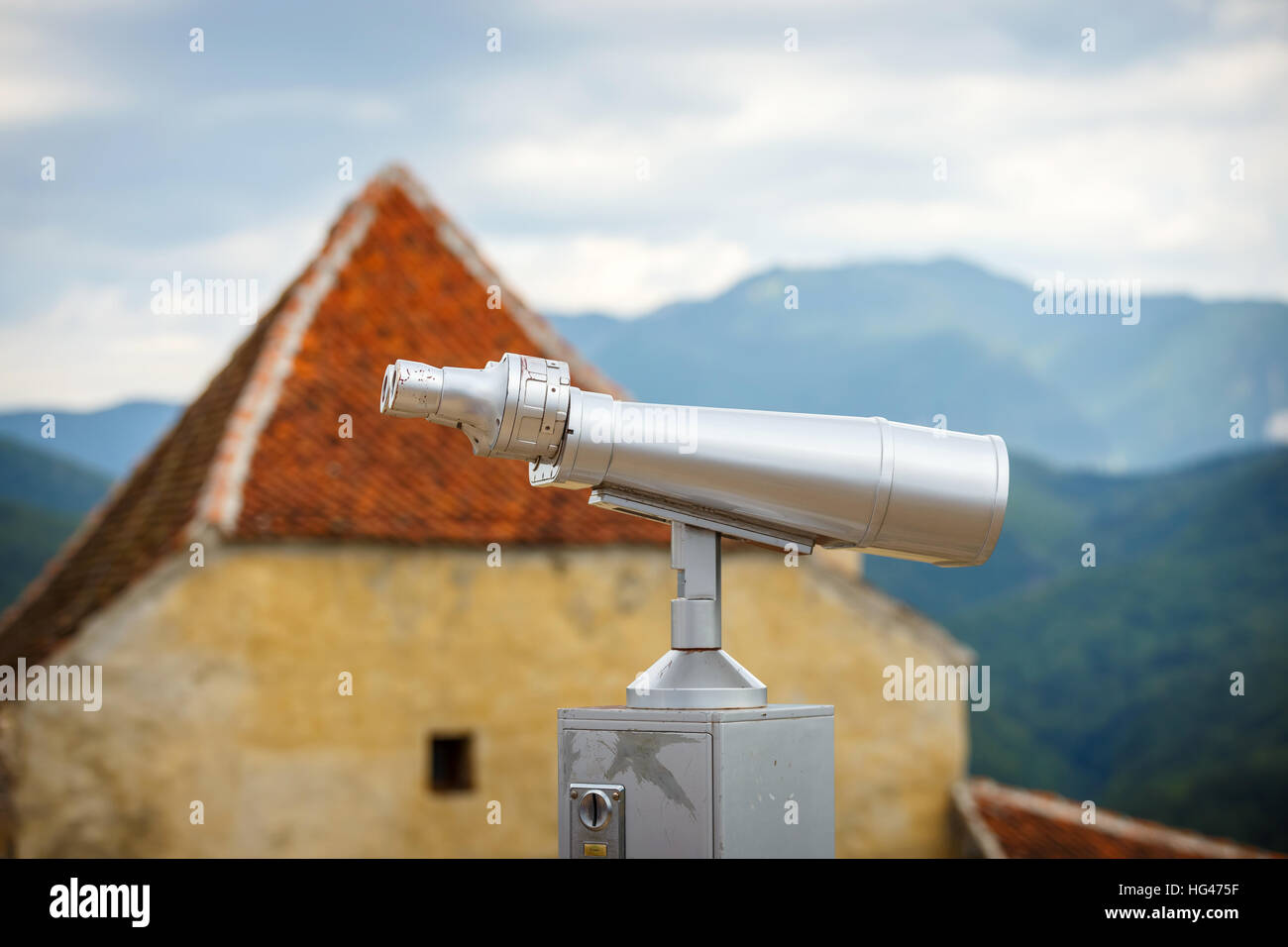 Large coin operated telescope used for viewing mountains Stock Photo