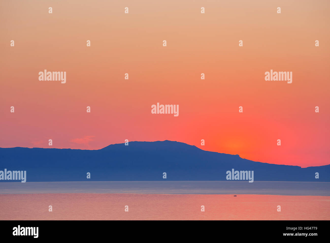 sunset over the mountain with reflection on the sea Stock Photo - Alamy