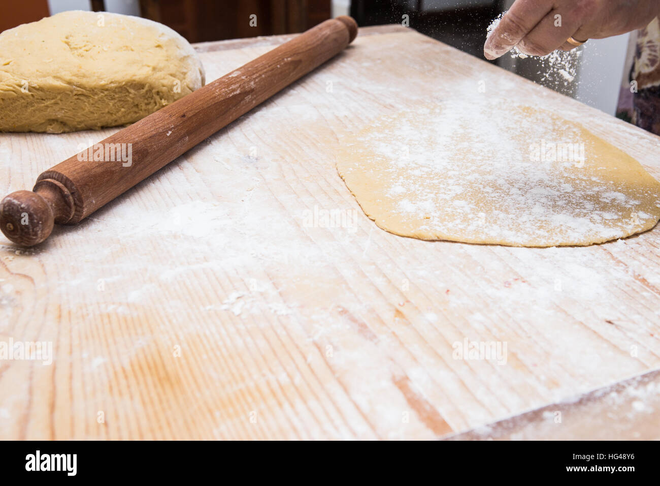 Woman hands kneading dough on kitchen table with rolling pin Stock ...