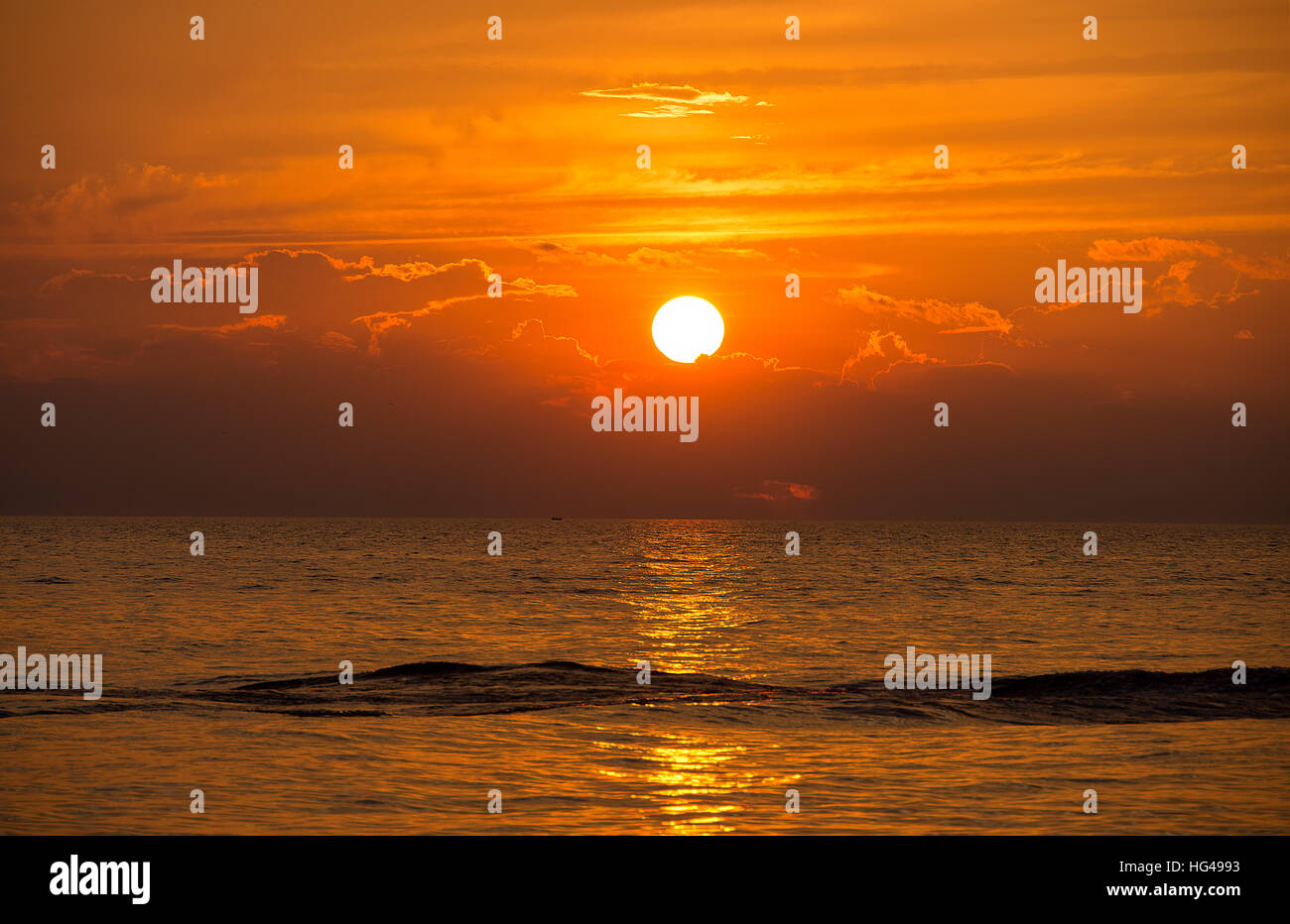 boat wake on Lake Michigan water with sunset sky Stock Photo