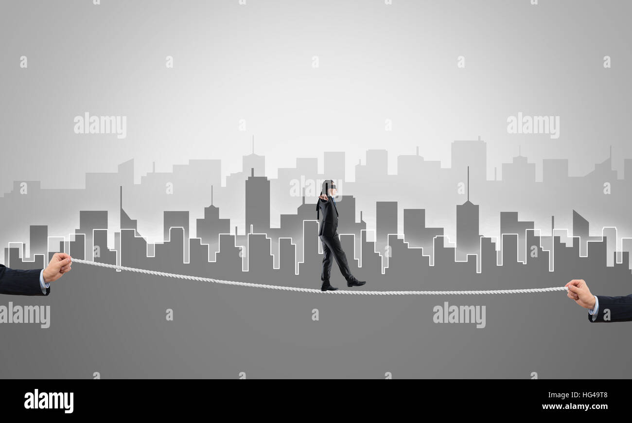 Business concept of risk support and assistance with man balancing on ...