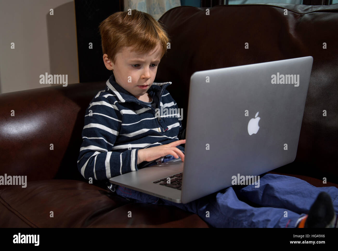 Child using technology. 5 year old boy with a laptop computer Stock ...