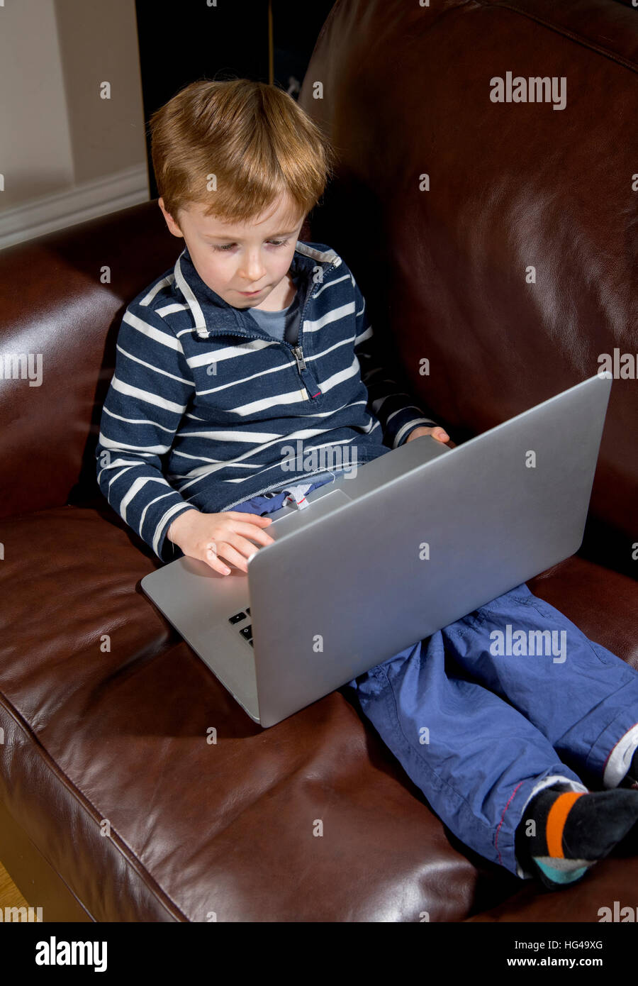 Child using technology hi-res stock photography and images - Alamy