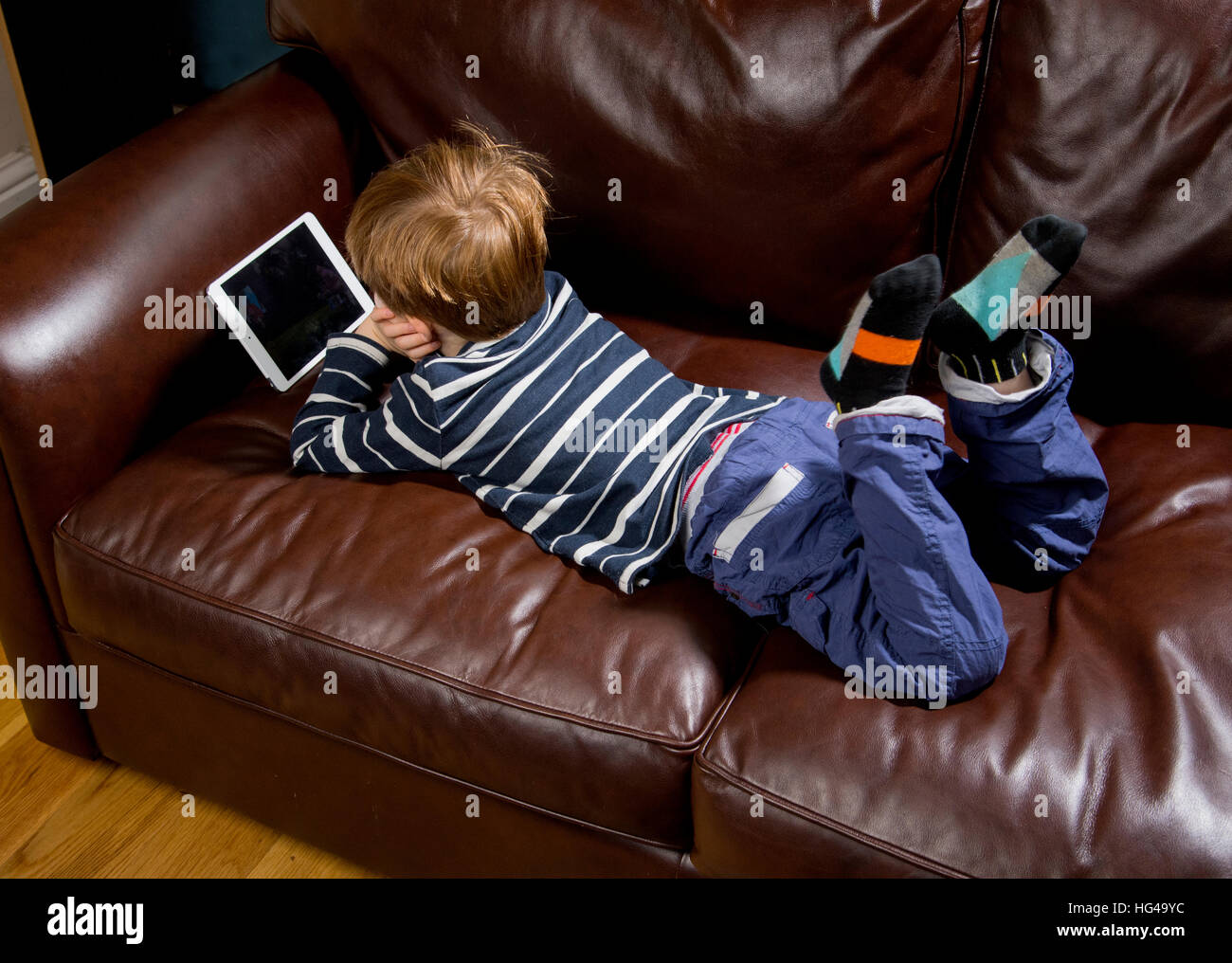 Child using technology. 5 year old boy with a tablet computer or iPad