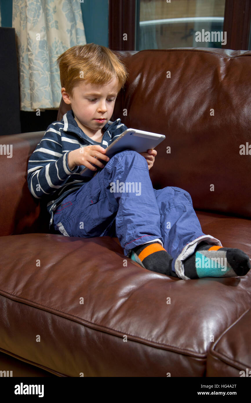 Child using technology. 5 year old boy with a tablet computer or iPad