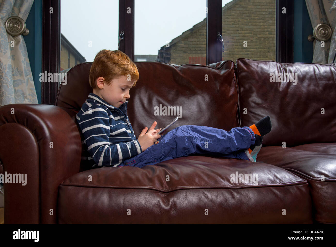 Child using technology. 5 year old boy with a tablet computer or iPad