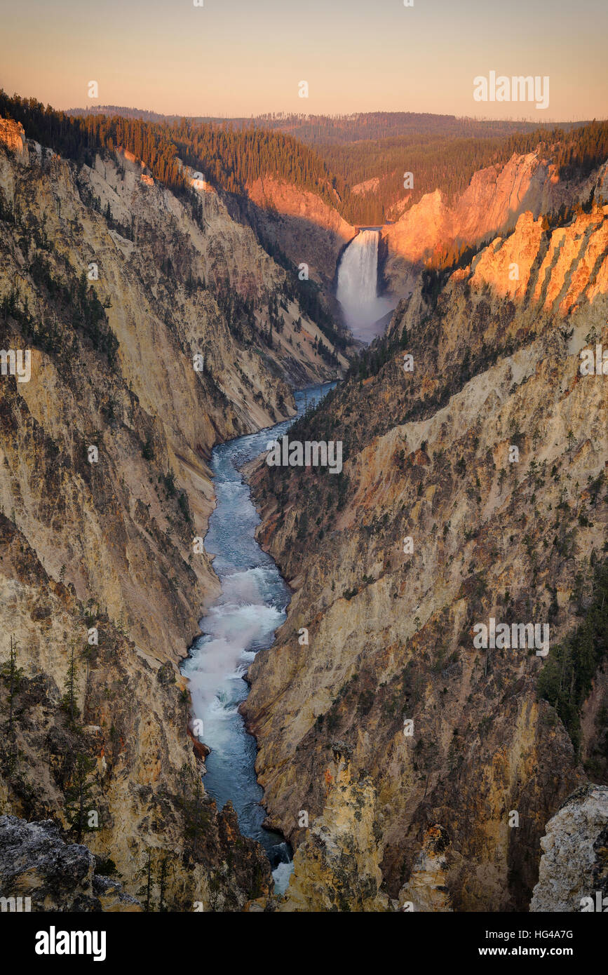 First morning light at Lower Falls Yellowstone river, Grand canyon of the Yellowstone National Park. Clear sky morning with water fall and river throu Stock Photo