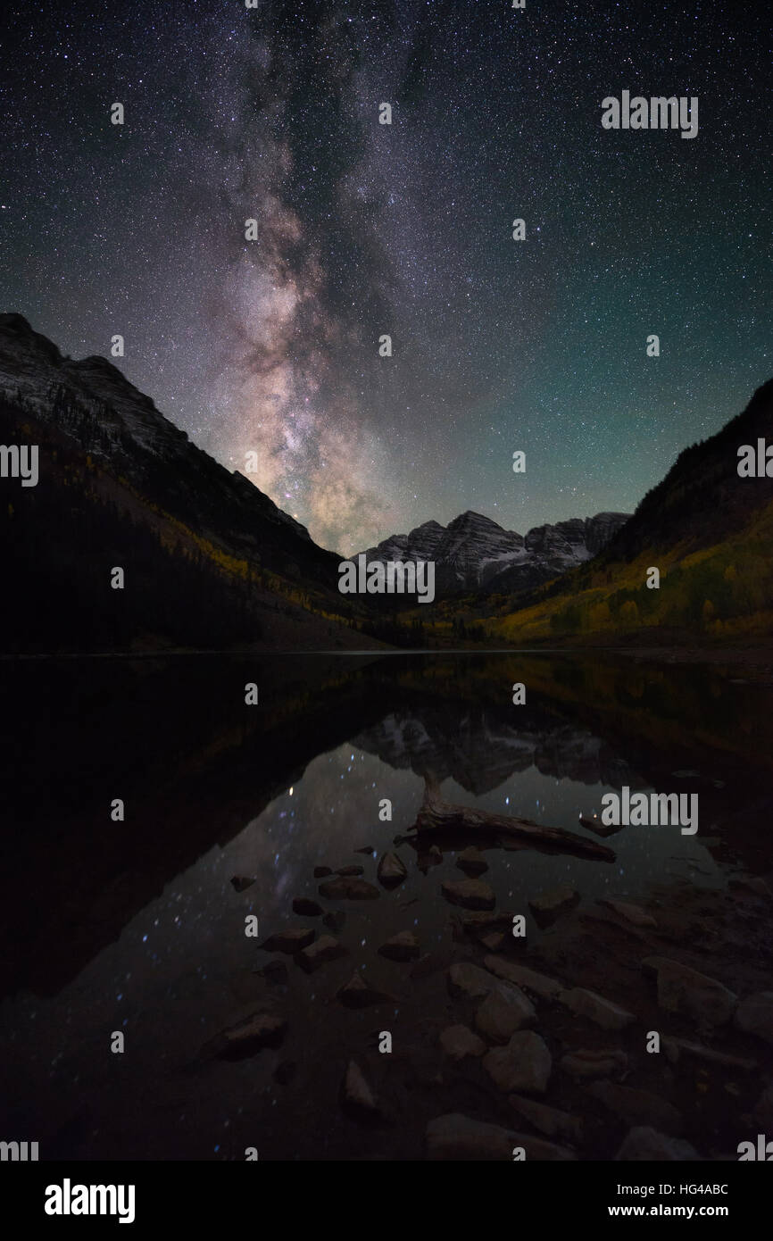 Bright and beautiful milky way over Maroon Bells, Colorado. Amazing reflection of the milky way on Maroon lake during Fall color. Stock Photo