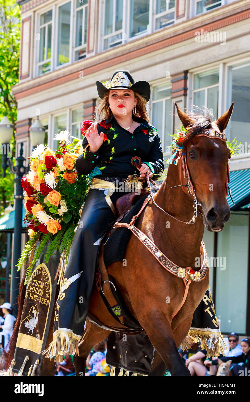 Portland, Oregon, USA - JUNE 7, 2014: Miss Thunder Mountain Pro Rodeo Queen, Brianna Howell in Grand floral parade through Portland downtown. Stock Photo