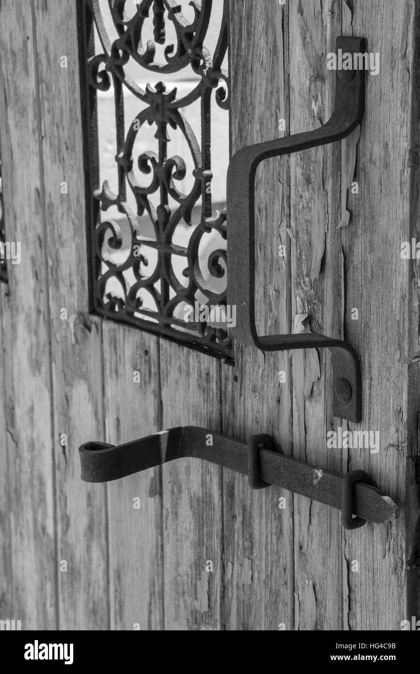 Old black and white wooden door with iron handle Stock Photo - Alamy