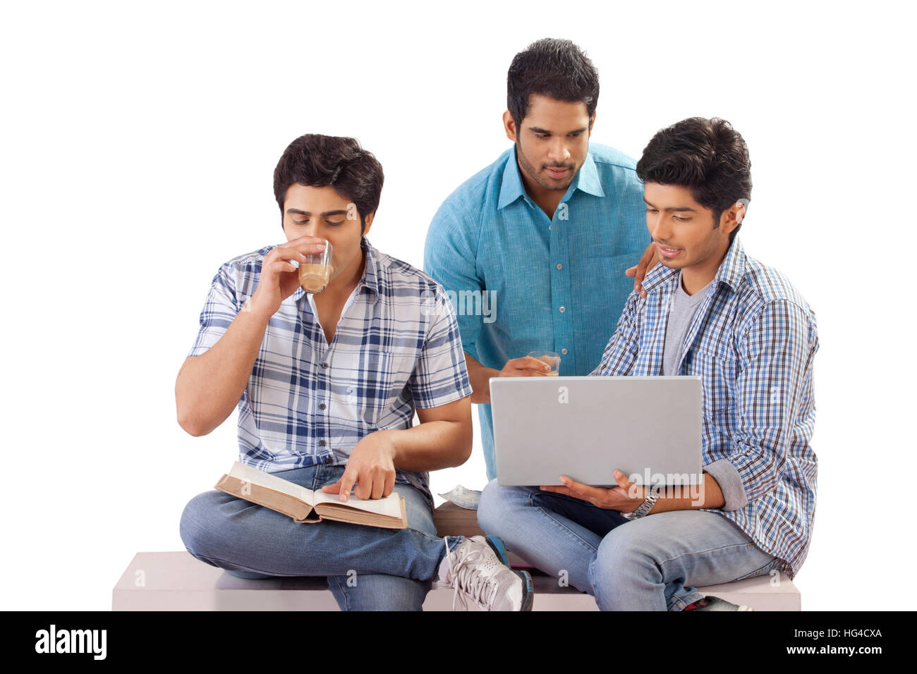 Three friends studying using laptop Stock Photo