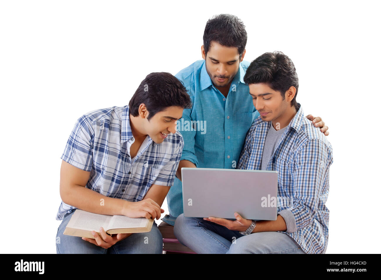 Three friends studying using laptop Stock Photo