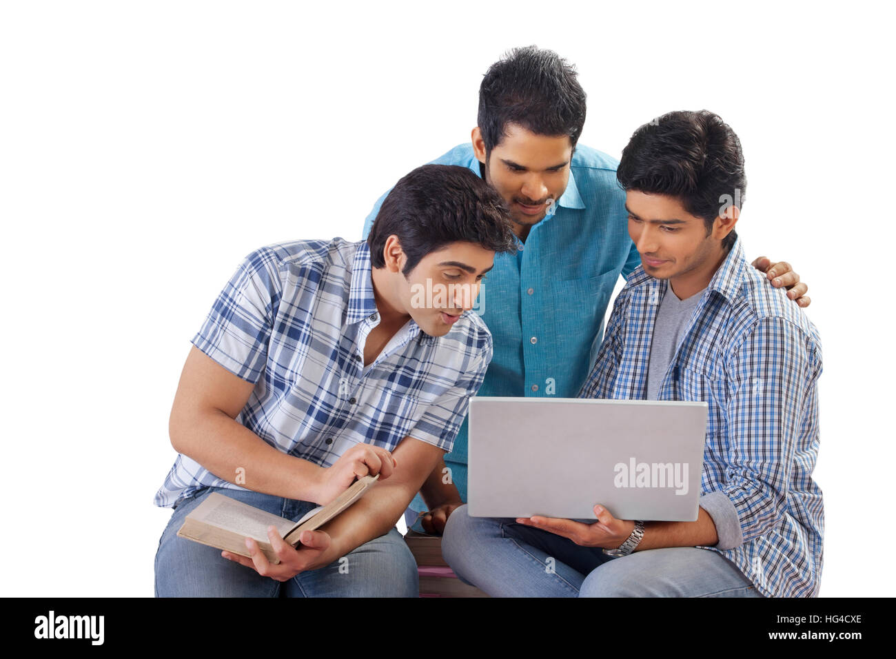 Three friends studying using laptop Stock Photo