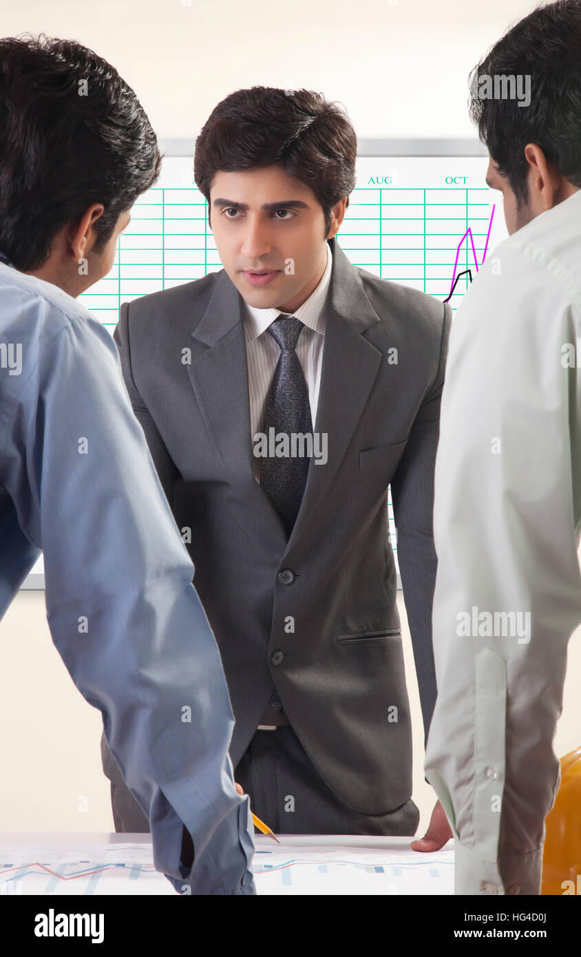 Businessman presenting to colleagues Stock Photo