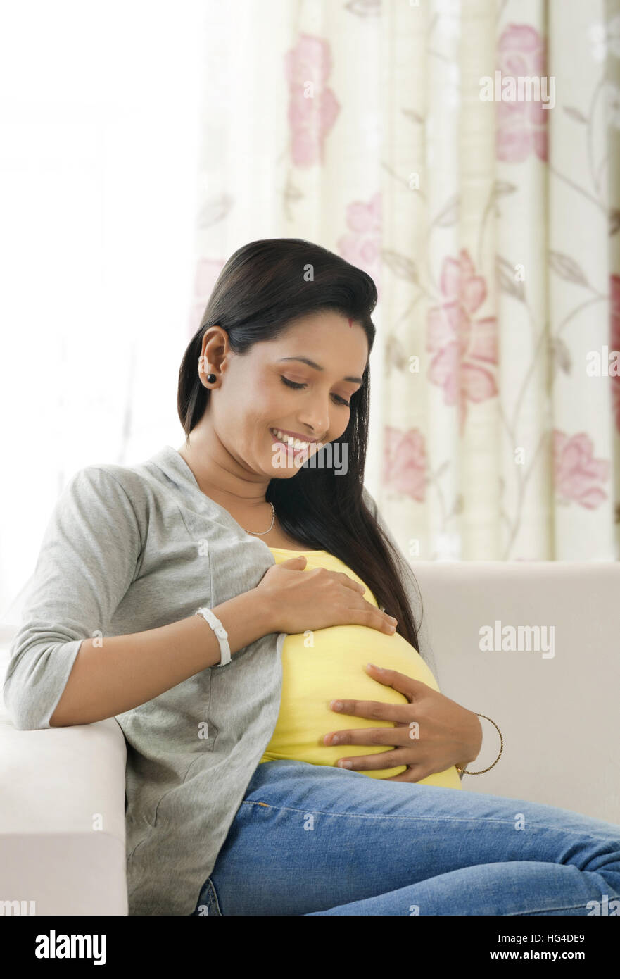 Pregnant woman holding her belly Stock Photo - Alamy