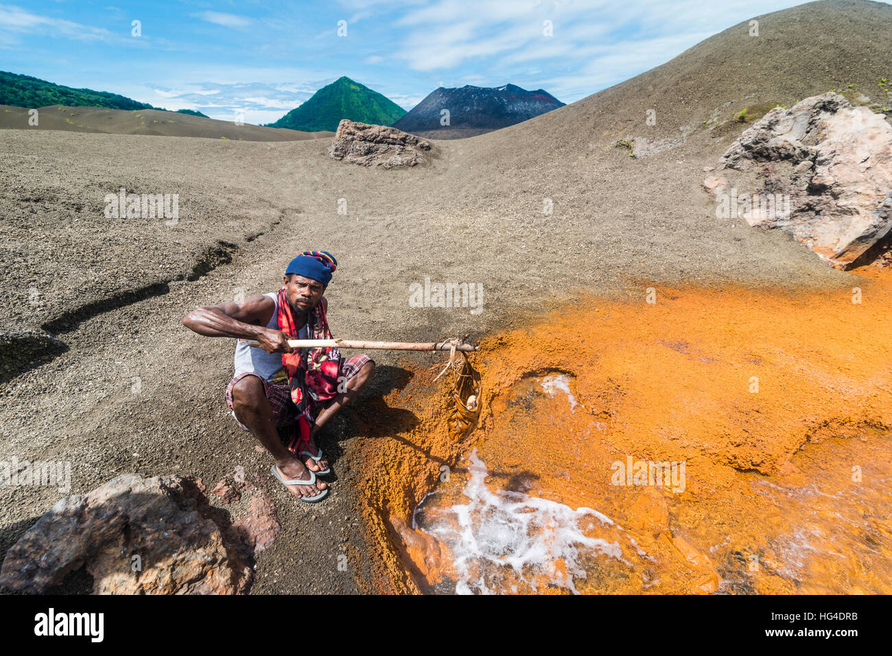 Man boiling Megapode eggs in a sulphur stream of Volcano Tavurvur, Rabaul, East New Britain, Papua New Guinea, Pacific Stock Photo