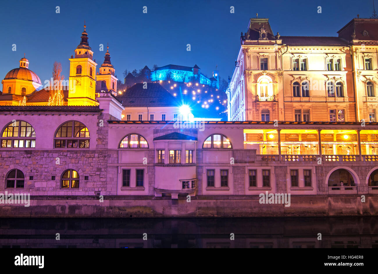 St. Nicholas cathedral and Ljubljanas castle, illuminated for New Years celebration Stock Photo