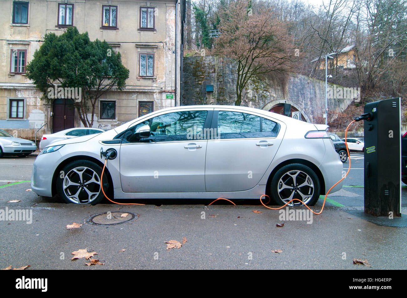 Electric car, parked and charging a battery Stock Photo