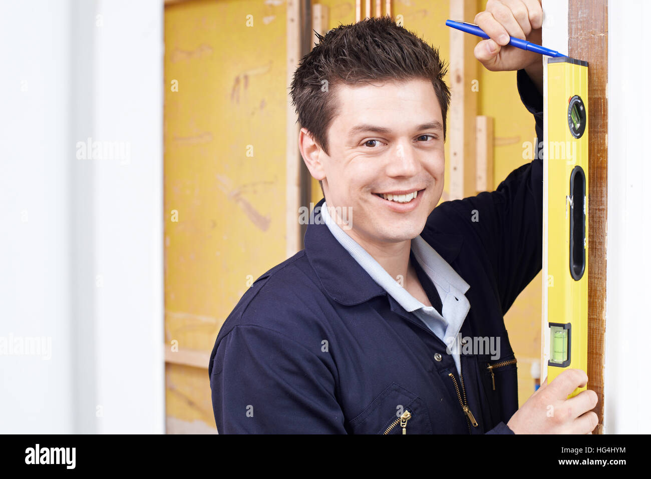 Portrait Of Builder Checking Work With Spirit Level Stock Photo - Alamy