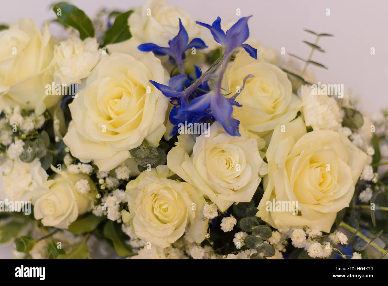 Wedding flower arrangement for top table with roses and blue flowers Stock Photo