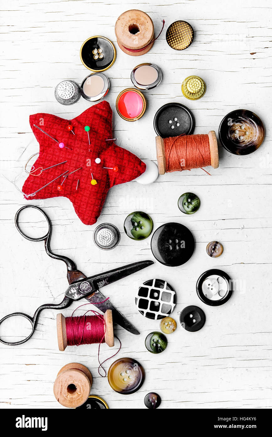 Threads and set of buttons from clothing on light background Stock ...