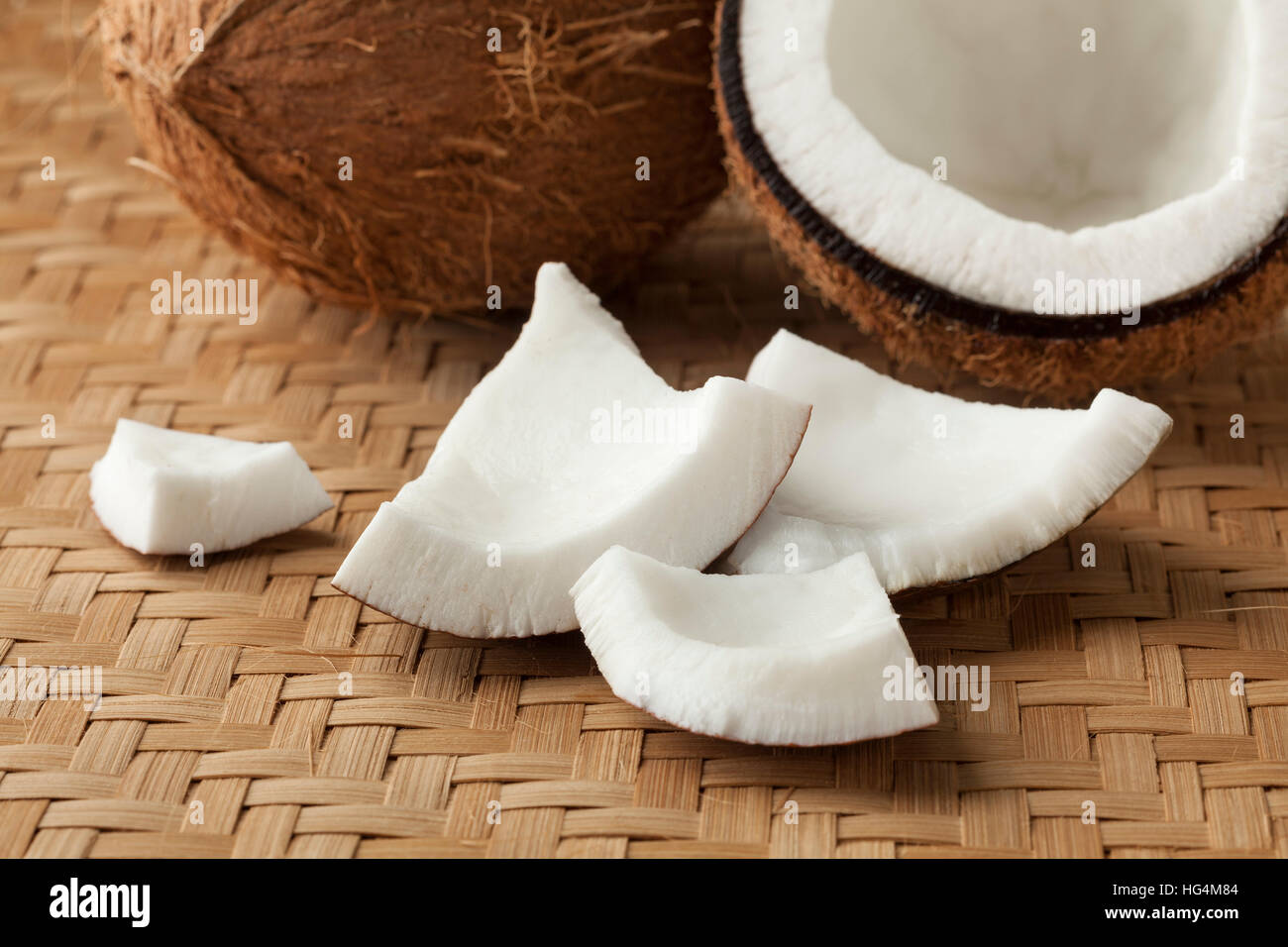 Cracked fresh coconut with pieces Stock Photo