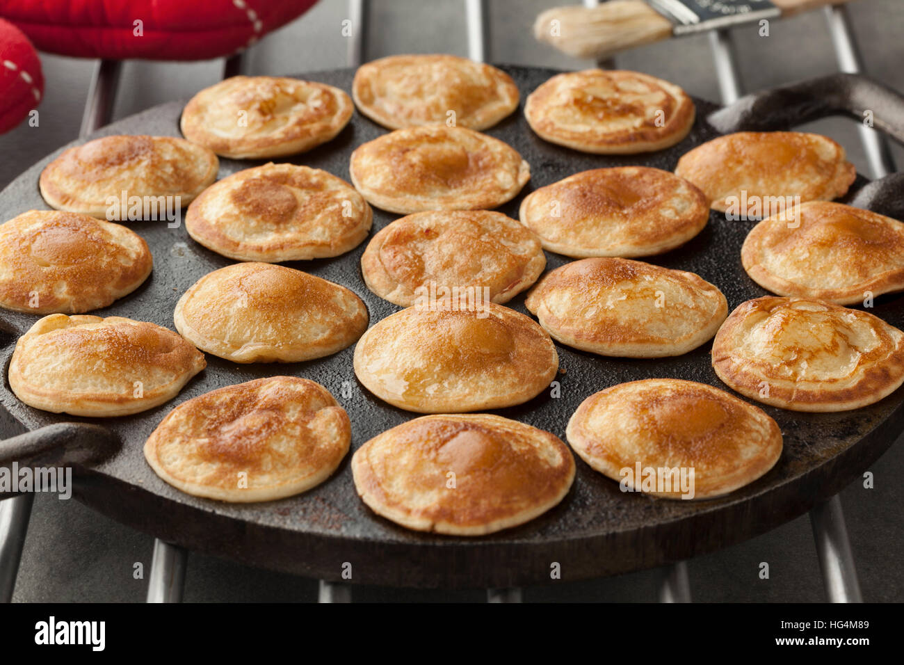 https://c8.alamy.com/comp/HG4M89/baking-dutch-mini-pancakes-called-poffertjes-in-a-special-skillet-HG4M89.jpg