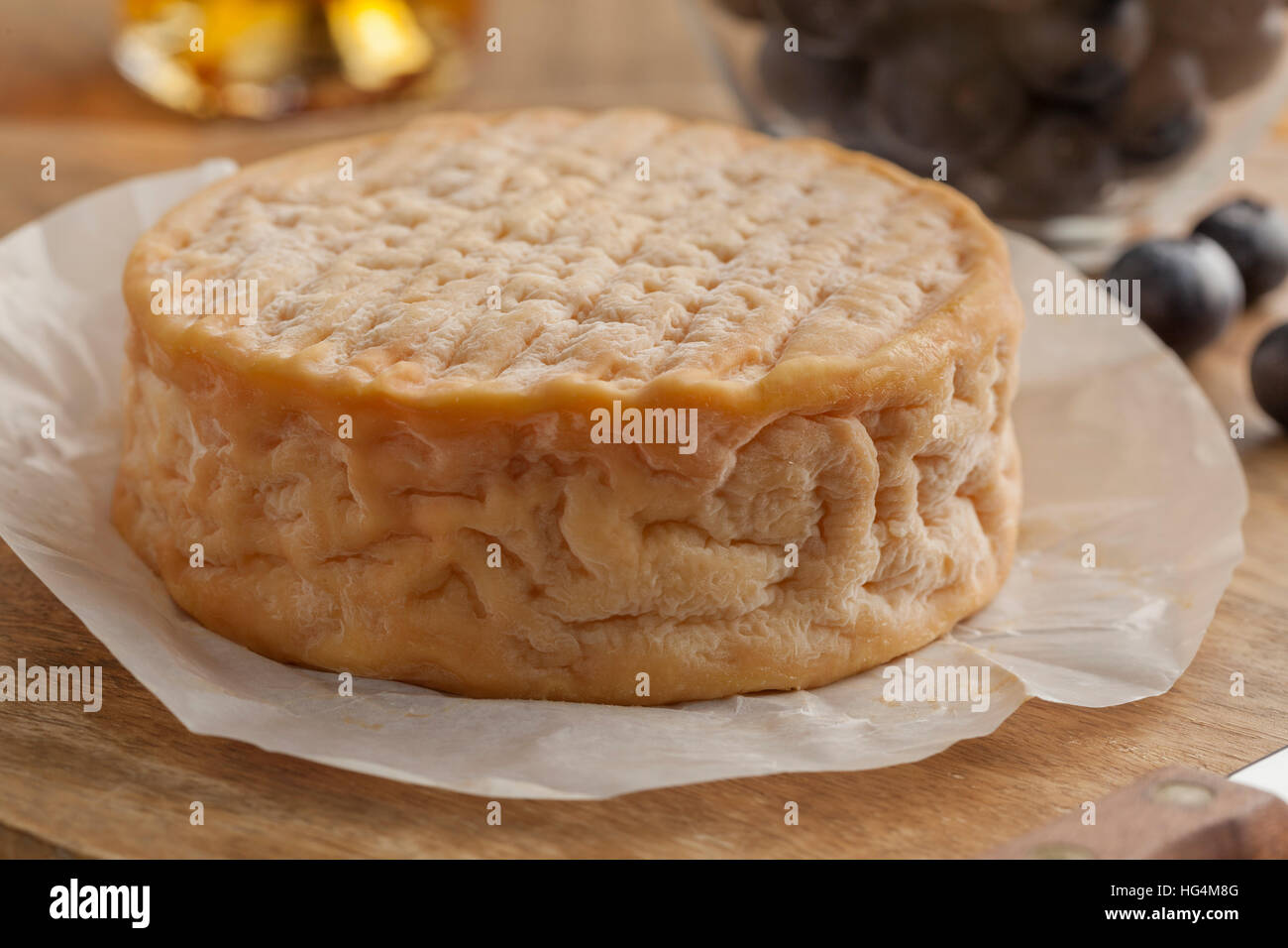 Whole french creamy ripe Epoisses cheese close up Stock Photo