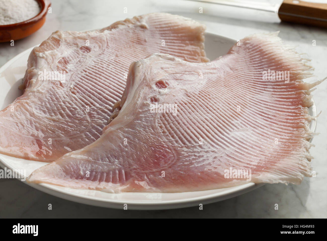 Cooking fresh raw stingray fish wings Stock Photo