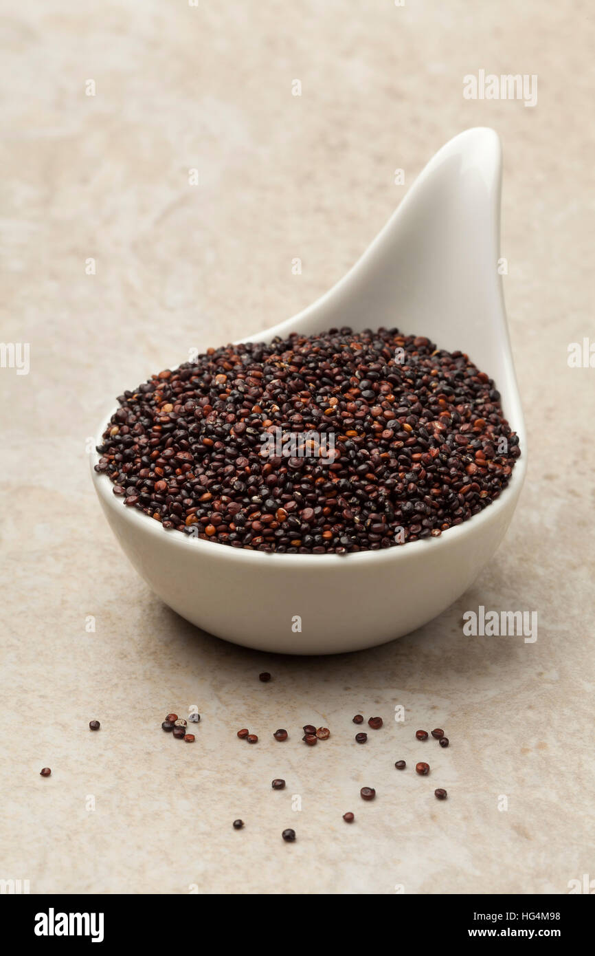 Raw black Quinoa in a white spoon Stock Photo