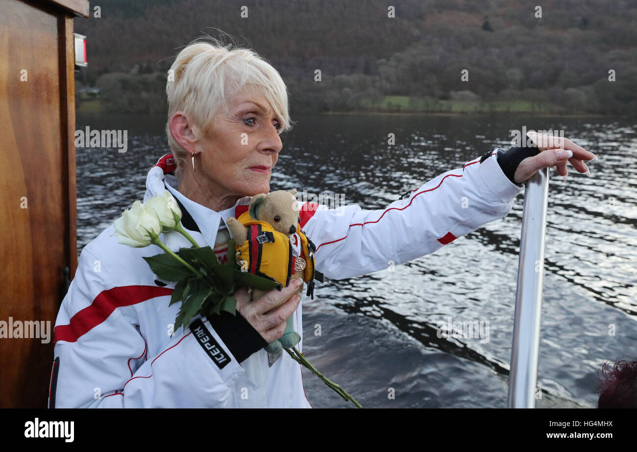 Gina Campbell, the daughter of world land and water speed record holder Donald Campbell, holds his mascot, a teddy bear named Mr Whoppit, as she marks the 50th anniversary of the fatal crash there of his jet-powered Bluebird boat at Lake Coniston. Stock Photo