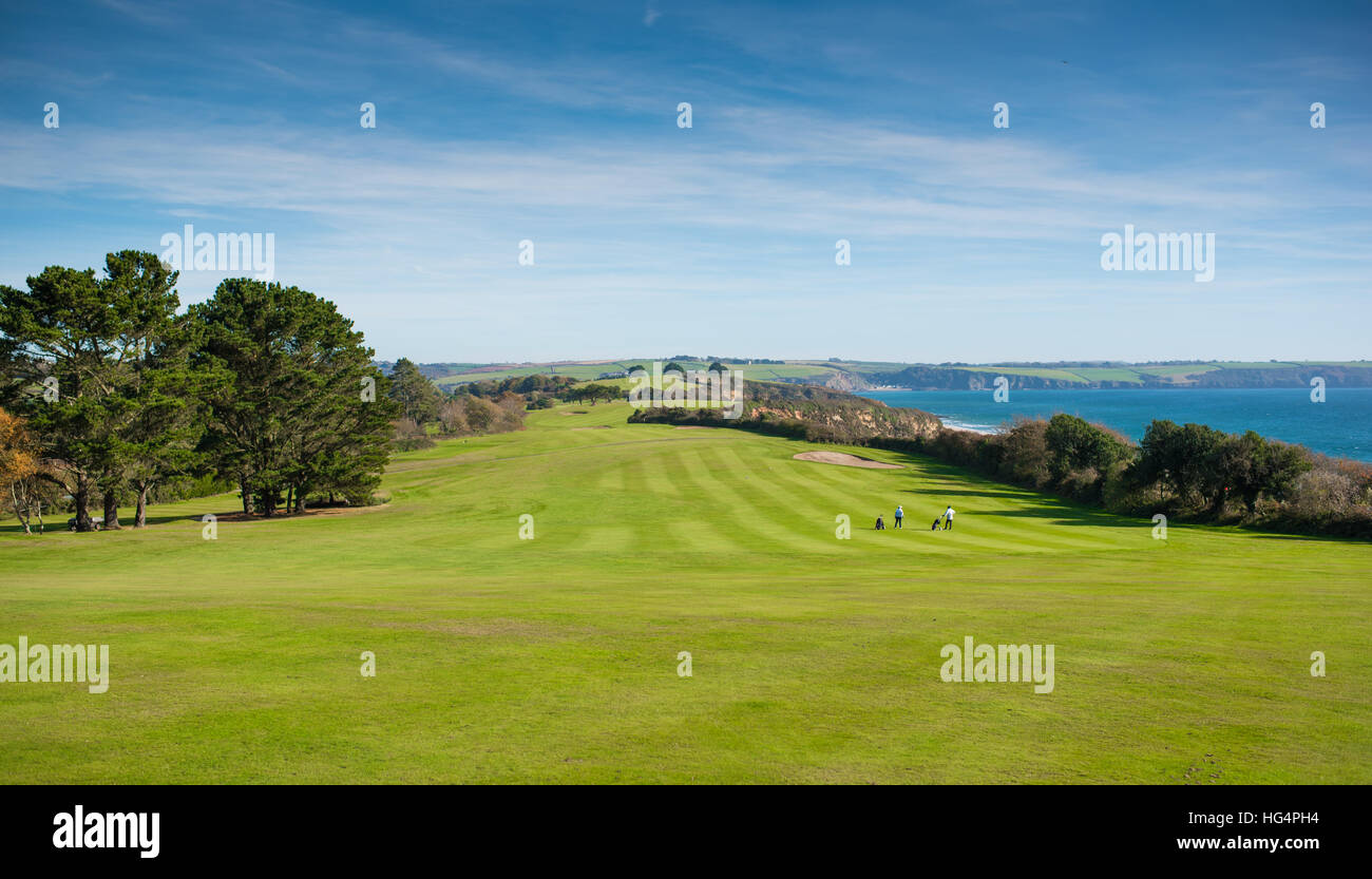 A beautiful golf course with dramatic sky near the sea. Stock Photo