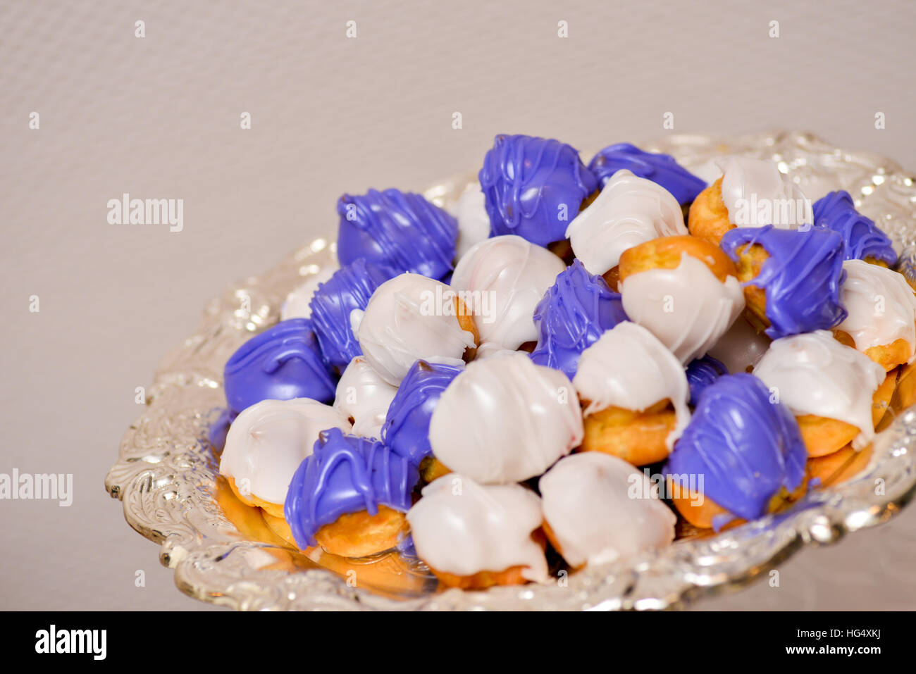 Cakes filled with cream frosting purple and white in daylight Stock Photo