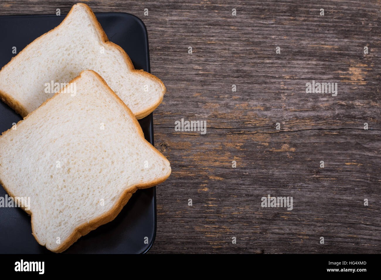 Slices of bread on the plate on the table in natural light Stock Photo