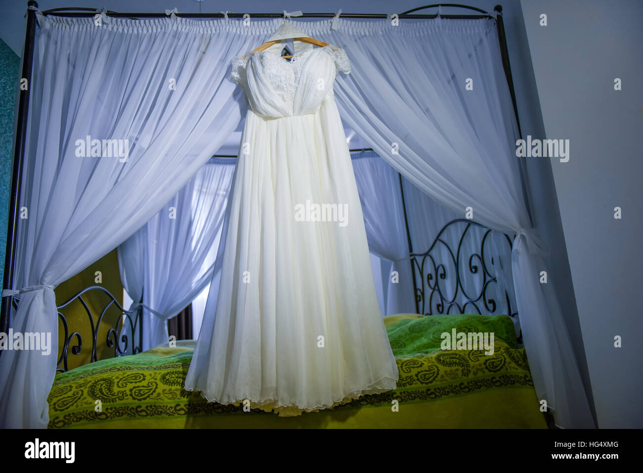 Wedding dress hanging in the house in daylight Stock Photo