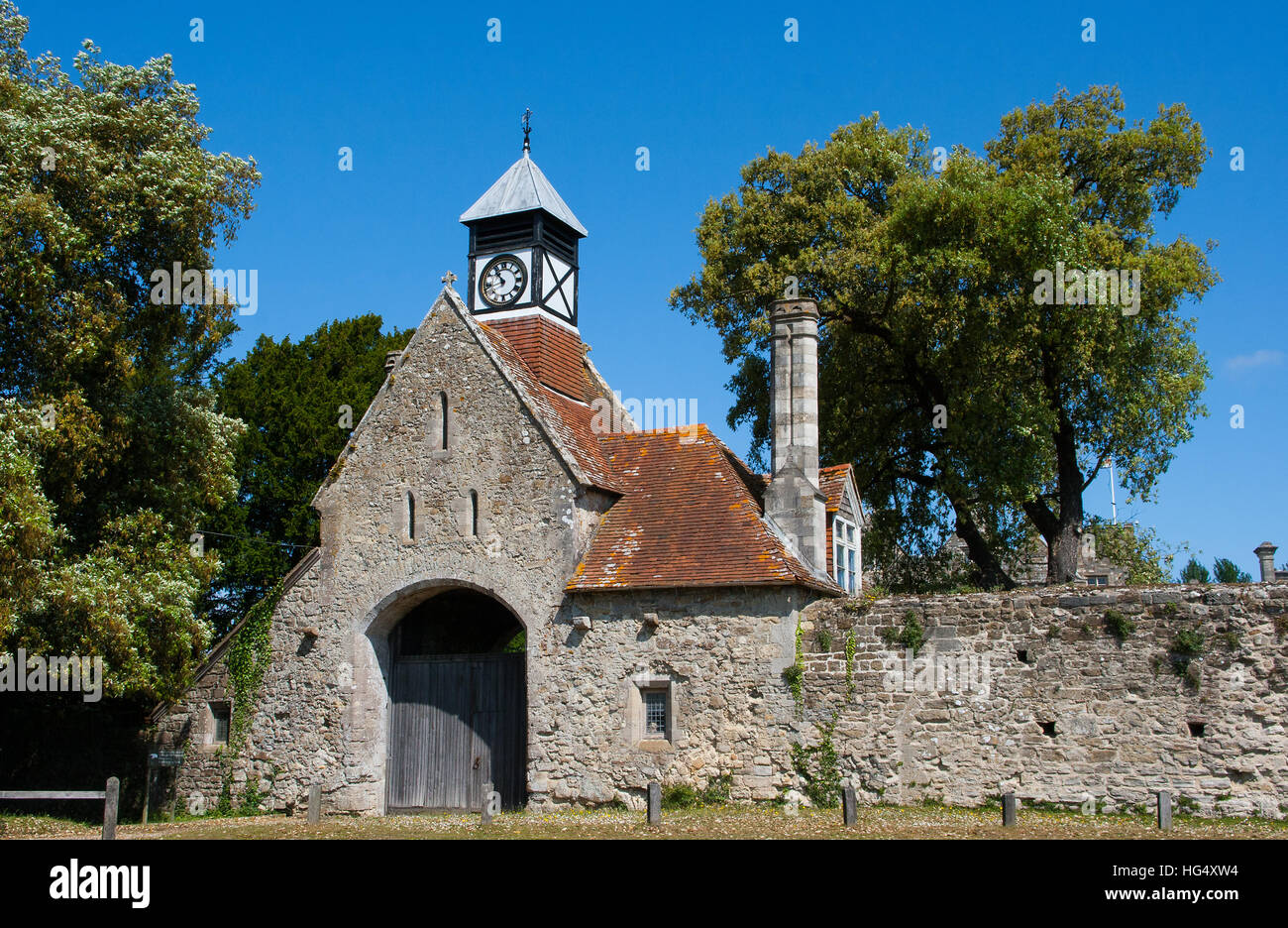 The ancient stone built gatehouse with Tudor style clock tower of