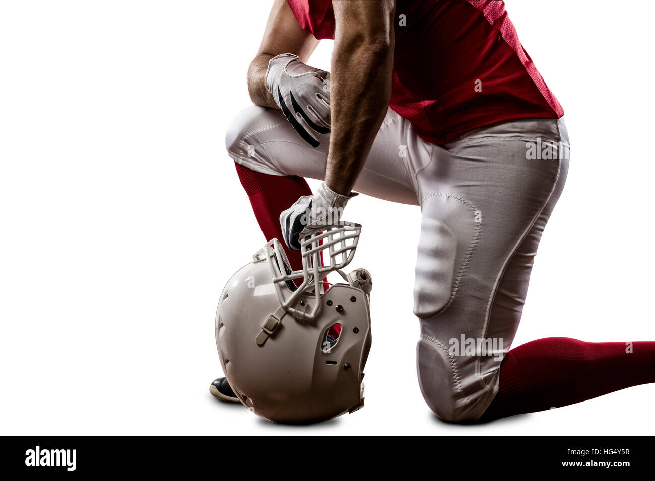 Football Player with a red uniform on his knees, on a white background