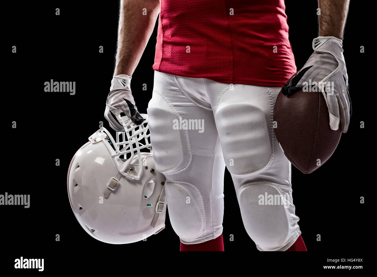 Football Player with a red uniform on a Black background Stock Photo